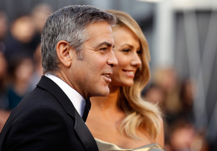 Image: George Clooney, best actor nominee for his role in \"The Descendants\", and his girlfriend Stacy Keibler arrive at the 84th Academy Awards in Hollywood